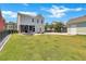 Expansive backyard with a well-maintained lawn, patio area, and detached garage, offering ample space at 2842 Rutherford Way, Charleston, SC 29414