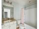 Bright bathroom with granite vanity, modern lighting, and tub with shower at 2842 Rutherford Way, Charleston, SC 29414