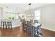 Open concept dining area with a rustic wood table next to the kitchen with a modern chandelier at 2842 Rutherford Way, Charleston, SC 29414