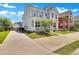 View of the home's exterior with a long driveway leading to a detached garage and fenced yard at 2842 Rutherford Way, Charleston, SC 29414