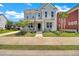 Charming two-story home with a welcoming front porch, landscaped yard, and an American flag at 2842 Rutherford Way, Charleston, SC 29414