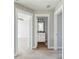Upstairs hallway with bedroom entrance, and bathroom with granite vanity and modern lighting at 2842 Rutherford Way, Charleston, SC 29414