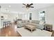 Spacious open living room with sectional sofa and wood flooring, and adjoined to the kitchen and dining area at 2842 Rutherford Way, Charleston, SC 29414