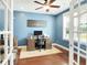 Bright office with wood floors, ceiling fan, area rug, desk and blue walls at 2842 Rutherford Way, Charleston, SC 29414