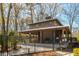 Outdoor pavilion with fireplace, picnic tables and covered area surrounded by mature trees and a black fence at 2842 Rutherford Way, Charleston, SC 29414