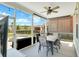 Relaxing screened-in porch with a dining table, ceiling fan, and comfortable seating overlooking the backyard at 2842 Rutherford Way, Charleston, SC 29414