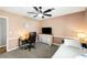 Bedroom with TV, desk and wood floors. Natural light comes in from the window at 2899 Doncaster Dr, Charleston, SC 29414