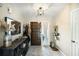 Charming foyer with wood door, rustic console table, neutral tile flooring and light fixture at 2899 Doncaster Dr, Charleston, SC 29414
