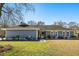 Charming single-story home featuring a well-manicured lawn and lush landscaping at 2899 Doncaster Dr, Charleston, SC 29414