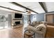 Cozy living room boasts a stone fireplace, beamed ceilings, and access to a patio at 2899 Doncaster Dr, Charleston, SC 29414