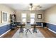 Bright office with wood floors, two windows, ceiling fan, and a gray and white rug at 2899 Doncaster Dr, Charleston, SC 29414