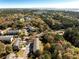 An aerial view of townhomes nestled among colorful trees with distant marsh views at 2920 Woodland Park Dr, Mount Pleasant, SC 29466