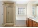 Bright bathroom with a glass shower and soaking tub beneath a window at 2920 Woodland Park Dr, Mount Pleasant, SC 29466