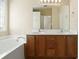 Bathroom featuring double sink vanity and a soaking tub with tiled surround and natural light at 2920 Woodland Park Dr, Mount Pleasant, SC 29466