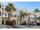 Exterior of townhome with palm trees, dark shutters, and a two-car garage at 2920 Woodland Park Dr, Mount Pleasant, SC 29466