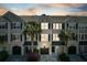 Exterior of townhome with palm trees, dark shutters, and a two-car garage at sunset at 2920 Woodland Park Dr, Mount Pleasant, SC 29466