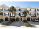 Beautiful townhomes featuring garages, front doors, and landscaped yards with palm trees at 2920 Woodland Park Dr, Mount Pleasant, SC 29466