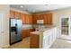 Bright kitchen with stainless steel refrigerator, wood cabinets, and eat-in breakfast bar at 2920 Woodland Park Dr, Mount Pleasant, SC 29466