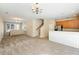 Spacious living room featuring plush carpeting, neutral walls, stairs and seamless flow to kitchen at 2920 Woodland Park Dr, Mount Pleasant, SC 29466