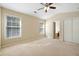 Spacious bedroom with plush carpeting, natural light, and access to the bathroom at 2920 Woodland Park Dr, Mount Pleasant, SC 29466