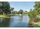 Scenic view of a pond with a fountain in front of townhomes with screened porches at 2920 Woodland Park Dr, Mount Pleasant, SC 29466