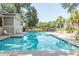 Clear, refreshing pool with surrounding lounge chairs, mature trees, and a nearby building at 2920 Woodland Park Dr, Mount Pleasant, SC 29466