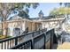 Charming pool house exterior featuring access ramp, neutral siding, and quaint architectural details at 2920 Woodland Park Dr, Mount Pleasant, SC 29466