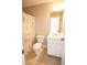 Cozy bathroom with floral shower curtain, white vanity, and neutral tile flooring at 2926 Sugarberry Lane Ln, Johns Island, SC 29455
