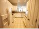 Well-lit kitchen with ample cabinet space and a view into the adjacent living area at 2926 Sugarberry Lane Ln, Johns Island, SC 29455