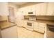 Functional kitchen featuring white appliances, granite counters, and a view to the living room at 2926 Sugarberry Lane Ln, Johns Island, SC 29455
