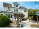 A beautiful backyard with an outdoor kitchen, pergola, and lush landscaping at 2961 Yachtsman Dr, Mount Pleasant, SC 29466