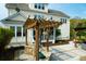 Lush backyard includes outdoor kitchen, seating, stone fireplace and patio covered by pergola at 2961 Yachtsman Dr, Mount Pleasant, SC 29466