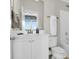 Bright bathroom featuring white cabinets, a toilet and shower-tub combo at 2961 Yachtsman Dr, Mount Pleasant, SC 29466