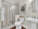 Well-lit bathroom featuring a glass shower, a pedestal sink, decorative mirror, and stylish tiled flooring at 2961 Yachtsman Dr, Mount Pleasant, SC 29466