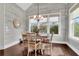 Charming dining room with gray shiplap walls, a stylish chandelier, and a view of the landscaped backyard at 2961 Yachtsman Dr, Mount Pleasant, SC 29466