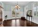 Elegant dining room with a chandelier, wainscoting, and French doors leading to an outdoor space at 2961 Yachtsman Dr, Mount Pleasant, SC 29466