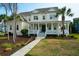 Beautifully landscaped property featuring a spacious two-story home with a grand porch at 2961 Yachtsman Dr, Mount Pleasant, SC 29466