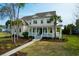 Beautiful two-story home boasts a manicured lawn, mature trees, and a welcoming front porch at 2961 Yachtsman Dr, Mount Pleasant, SC 29466