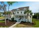 Charming two-story home featuring a welcoming front porch, well-manicured lawn, and mature trees adding to its curb appeal at 2961 Yachtsman Dr, Mount Pleasant, SC 29466