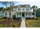 Beautiful two-story home boasts a classic design with a welcoming front porch, landscaped yard, and mature trees at 2961 Yachtsman Dr, Mount Pleasant, SC 29466