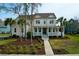 Beautiful two-story home boasts a manicured lawn, mature trees, and a welcoming front porch at 2961 Yachtsman Dr, Mount Pleasant, SC 29466