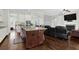Open-concept kitchen with granite island, seamlessly connecting to the living room with hardwood floors and fireplace at 2961 Yachtsman Dr, Mount Pleasant, SC 29466