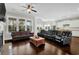 Spacious living room featuring dark hardwood floors, large windows offering plenty of natural light, and comfortable seating at 2961 Yachtsman Dr, Mount Pleasant, SC 29466