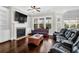 Bright living room with fireplace, built-in shelves, hardwood floors, and plenty of natural light from large windows at 2961 Yachtsman Dr, Mount Pleasant, SC 29466