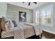 Inviting bedroom with a decorative shiplap wall, a four-poster bed, and plantation shutters for added privacy at 2961 Yachtsman Dr, Mount Pleasant, SC 29466