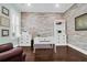 Bright home office with a white desk, shelving, wood-look accent wall, and shuttered windows at 2961 Yachtsman Dr, Mount Pleasant, SC 29466