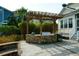 Outdoor stone kitchen with wooden pergola in landscaped backyard at 2961 Yachtsman Dr, Mount Pleasant, SC 29466