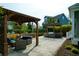 Inviting outdoor patio with comfortable seating, a pergola with a ceiling fan, and a stone firepit at 2961 Yachtsman Dr, Mount Pleasant, SC 29466