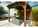 Stylish outdoor seating area beneath a wooden pergola with comfortable woven furniture and blue cushions at 2961 Yachtsman Dr, Mount Pleasant, SC 29466
