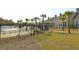 Fenced in pool area with lounge chairs and palm trees in front of a large building at 2961 Yachtsman Dr, Mount Pleasant, SC 29466